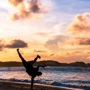 Silhouette of a person doing a balance exercise