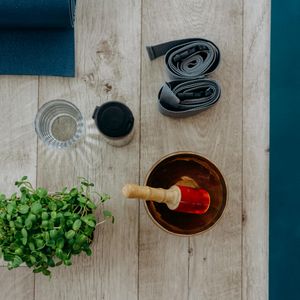 Yoga block and strap on a wooden floor